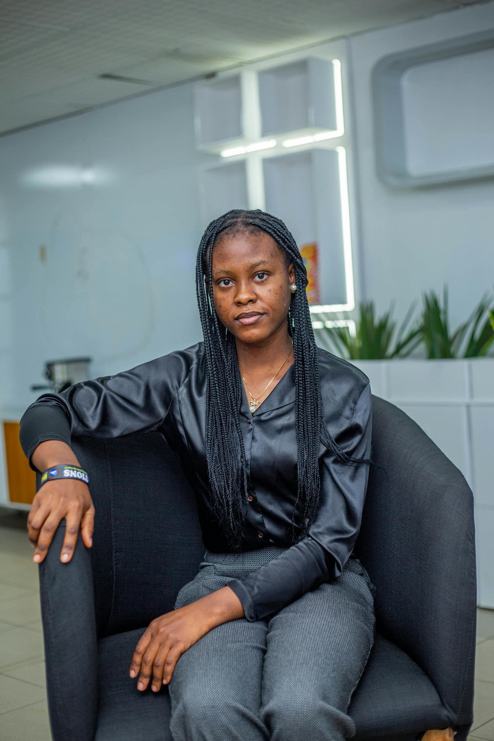 African salon customer seated in a modern beauty studio.