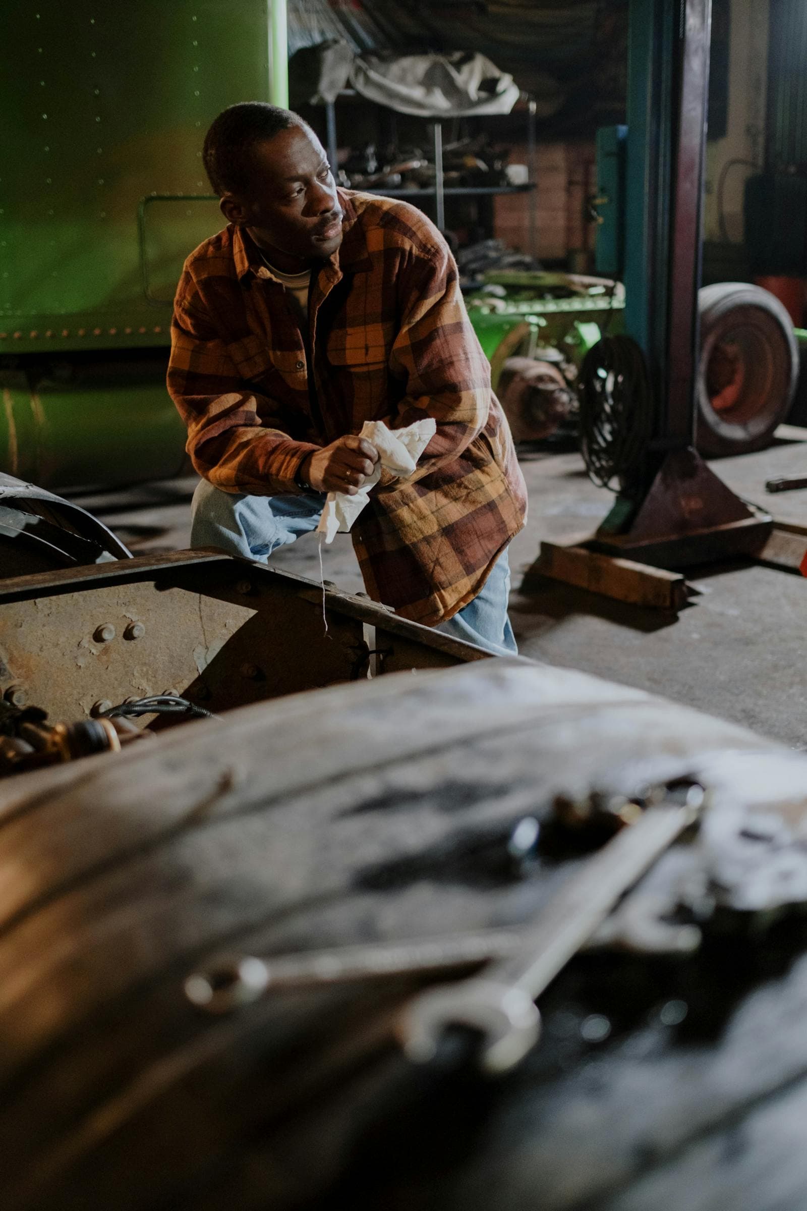 African mechanic working in a garage service workshop.
